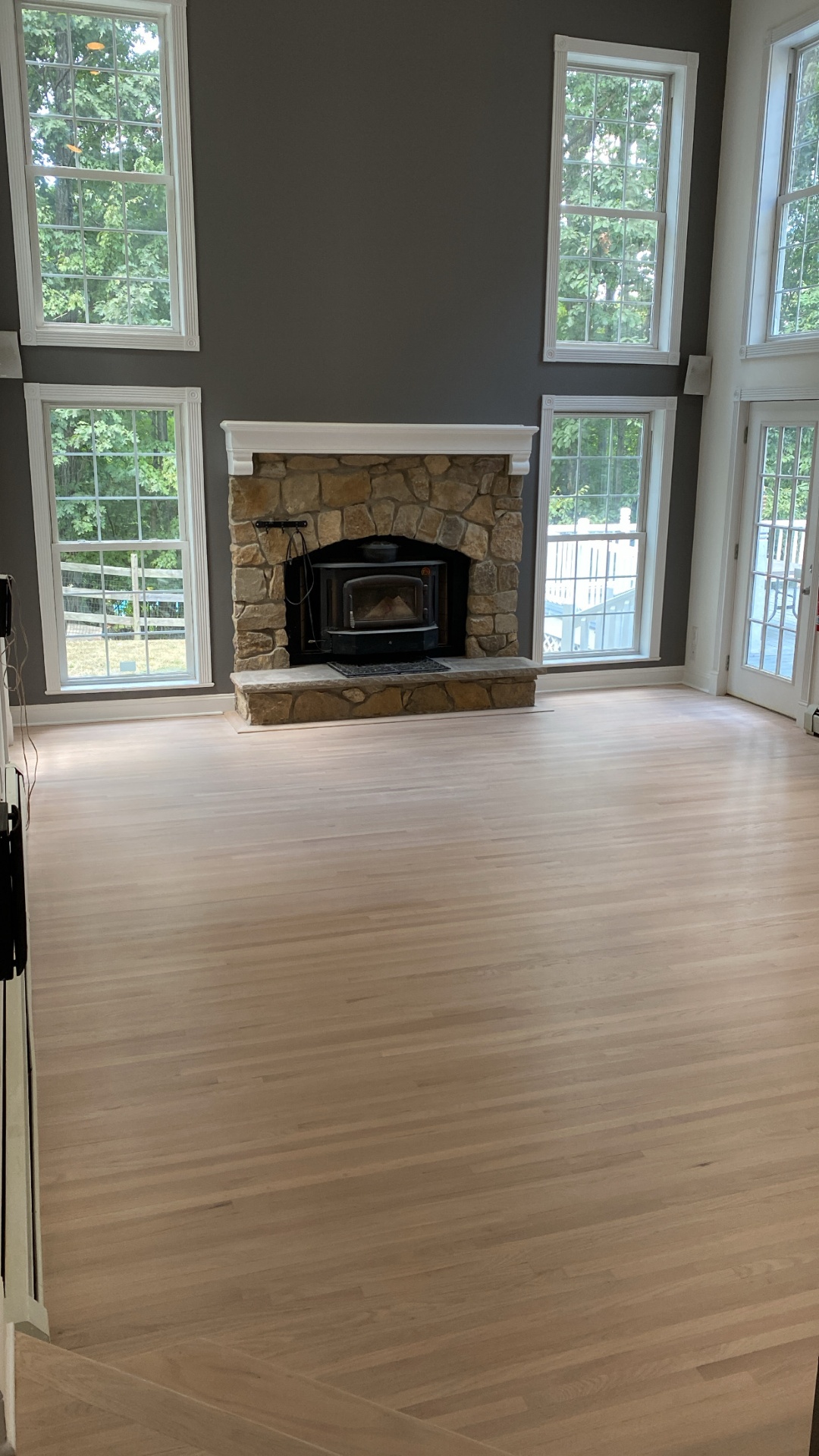Freshly sanded white oak floor by stone fireplace