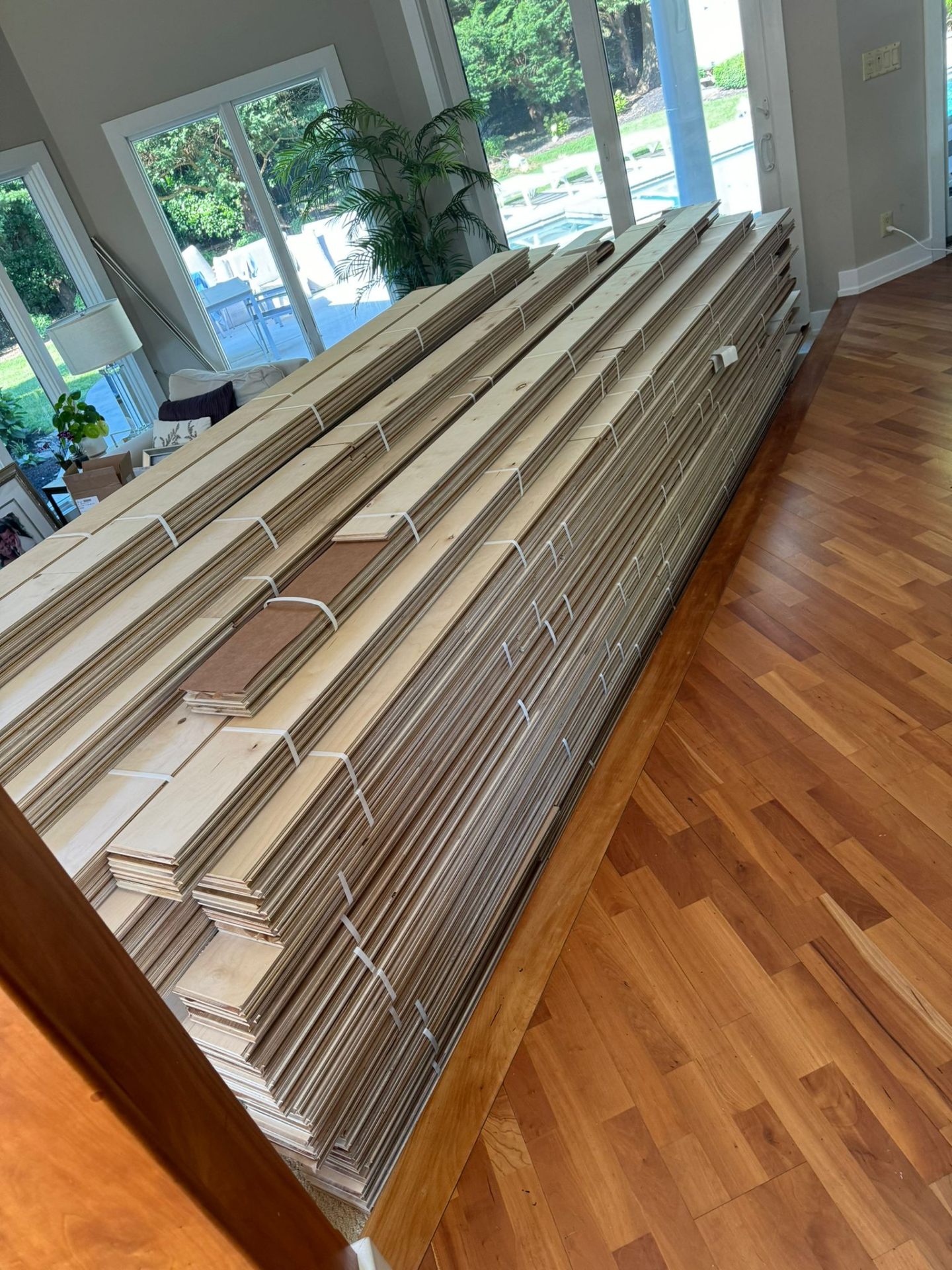 Fresh hardwood planks staged for installation
